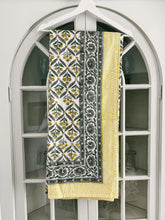 Load image into Gallery viewer, Yellow and gray geometric tablecloth hanging on a hanger