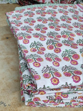Load image into Gallery viewer, Stack of pink and yellow floral fabric on a wooden surface