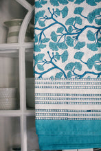 Load image into Gallery viewer, Teal and white patterned tablecloth on a shelf with kitchen items.