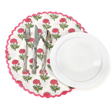 Load image into Gallery viewer, A set of pink and green placemats with a floral pattern and scallop edges on a white dining table.