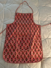 Load image into Gallery viewer, Pink patterned apron on a white quilted surface